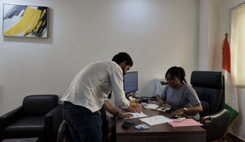 Ivoire Essentials and Foani International Training College representatives reviewing the partnership agreement in the office